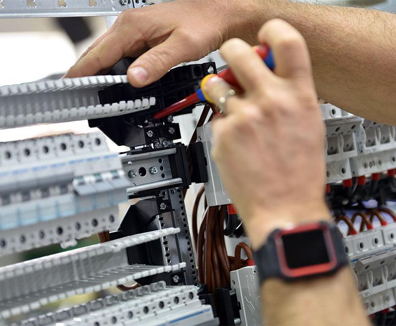 An electrician on a call-out at a cabinet